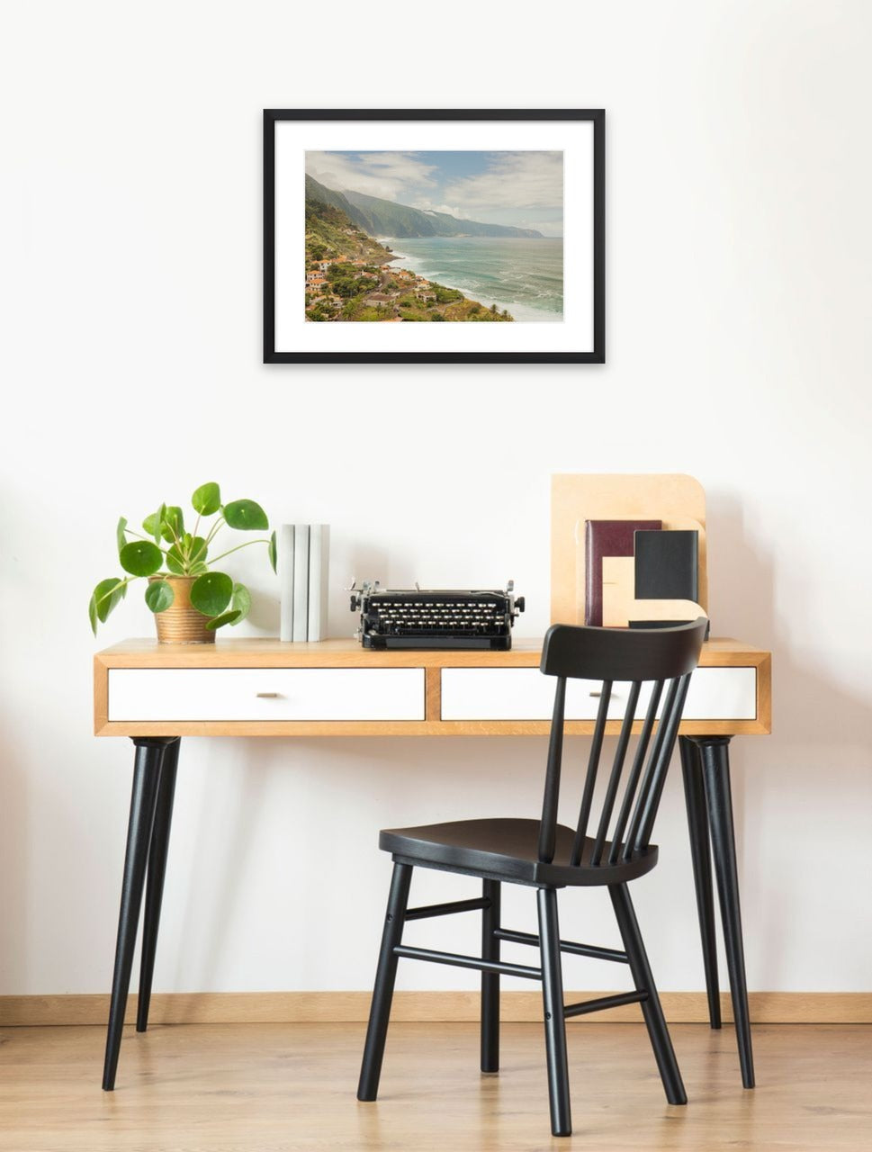 Black-framed print shown on a wall: A village on green cliffs above the Atlantic Ocean in Madeira, Portugal