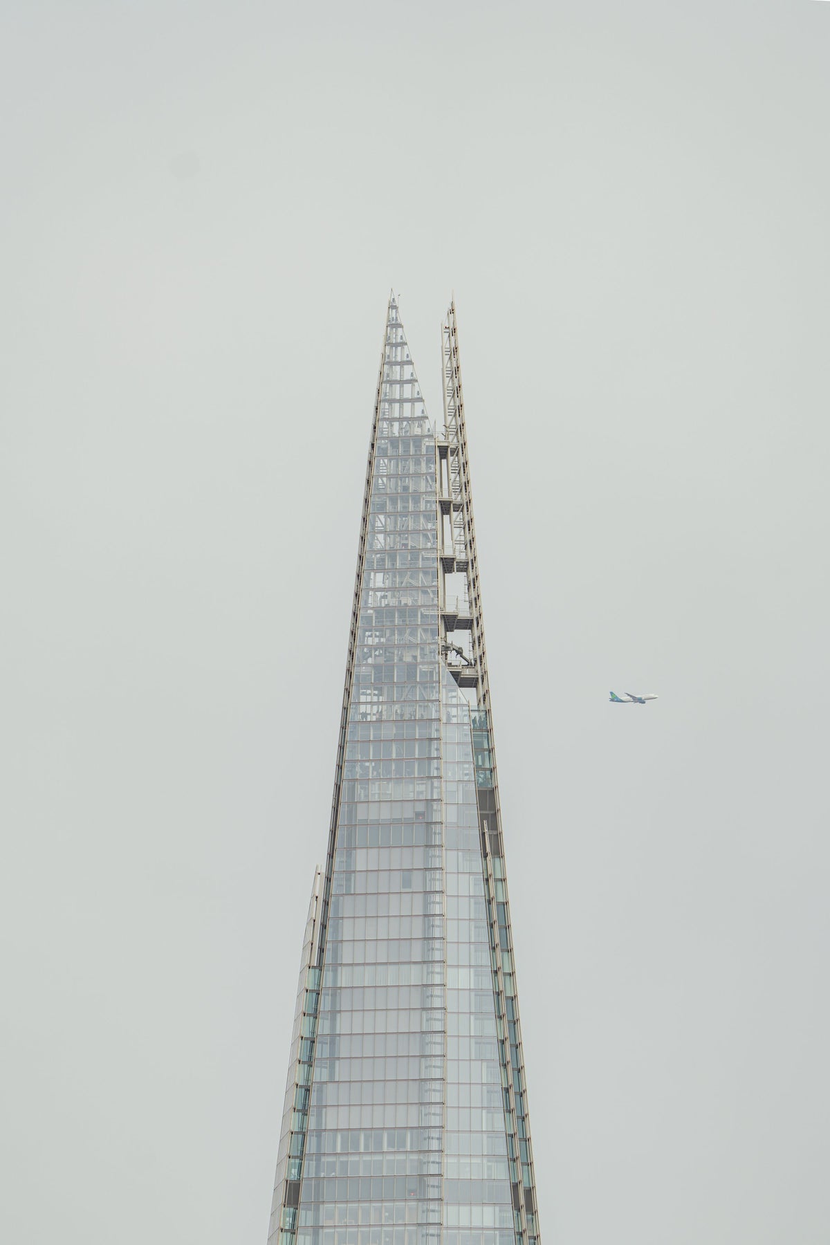 Looking up at The Shard skyscraper in London against a pale sky