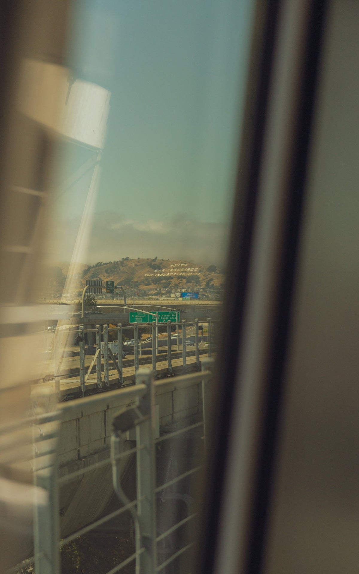 Blurred city view seen through a train window reflection