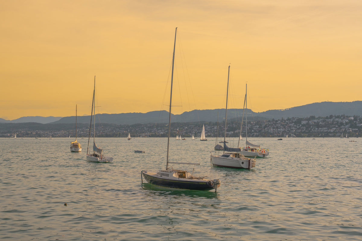 Sailboats resting on Lake Zurich in golden evening light, Switzerland