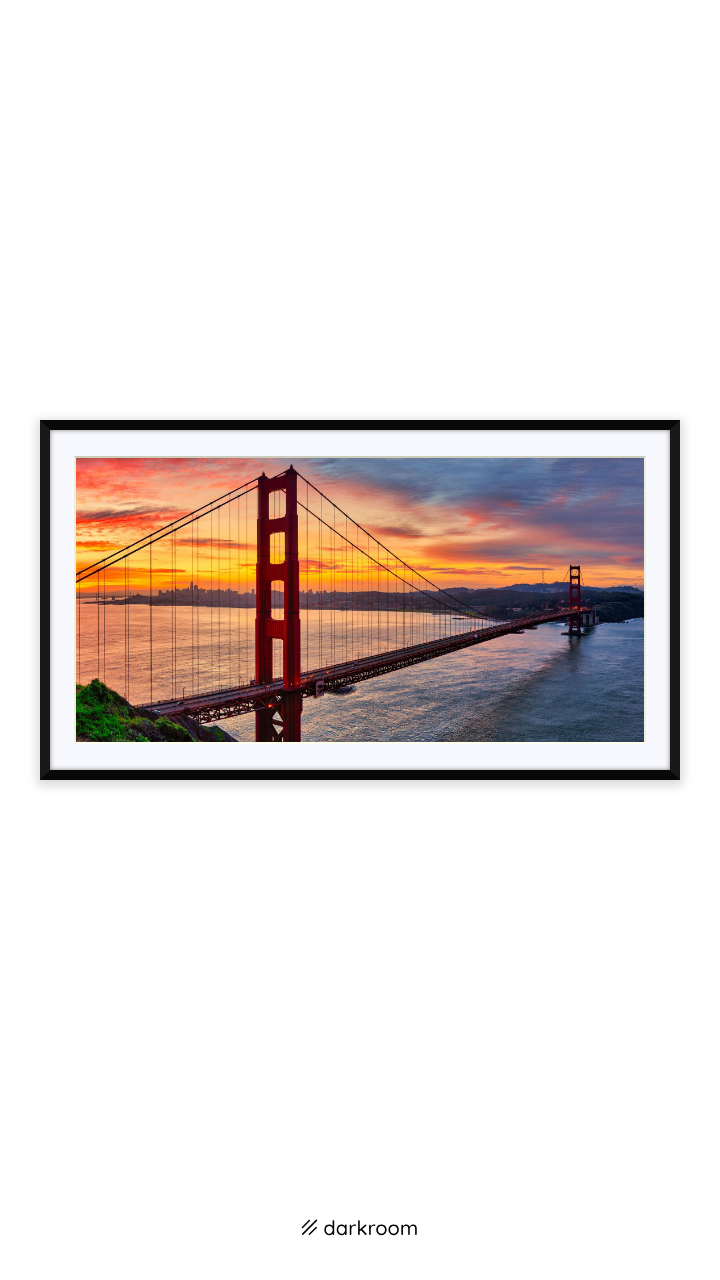 Black-framed print: Panorama of the Golden Gate Bridge under a pink and orange sunrise, San Francisco
