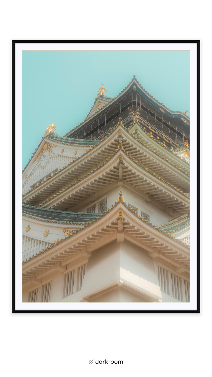 Black-framed print: Looking up at the white walls and green roof tiers of Osaka Castle, Japan