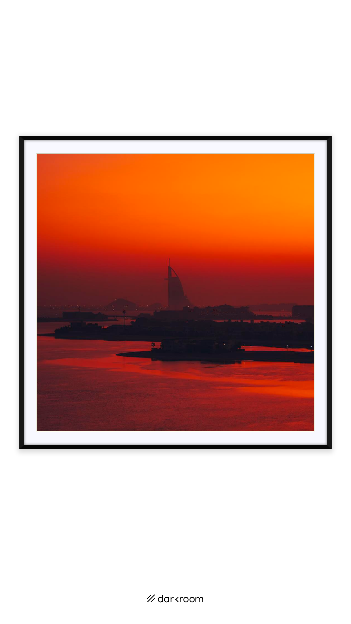 Black-framed print: Burj Al Arab silhouetted across red water at sunrise, Dubai