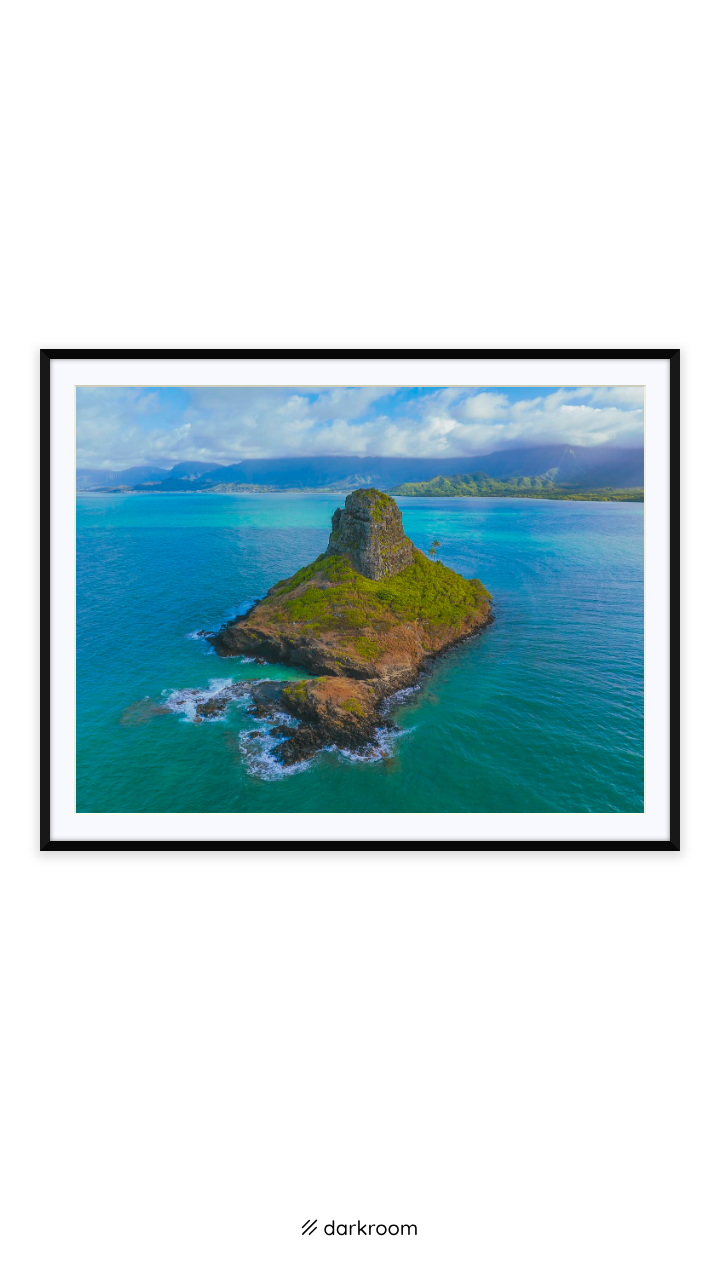 Black-framed print: Aerial photo of Mokolii Island in turquoise water with the Koolau mountains, Oahu