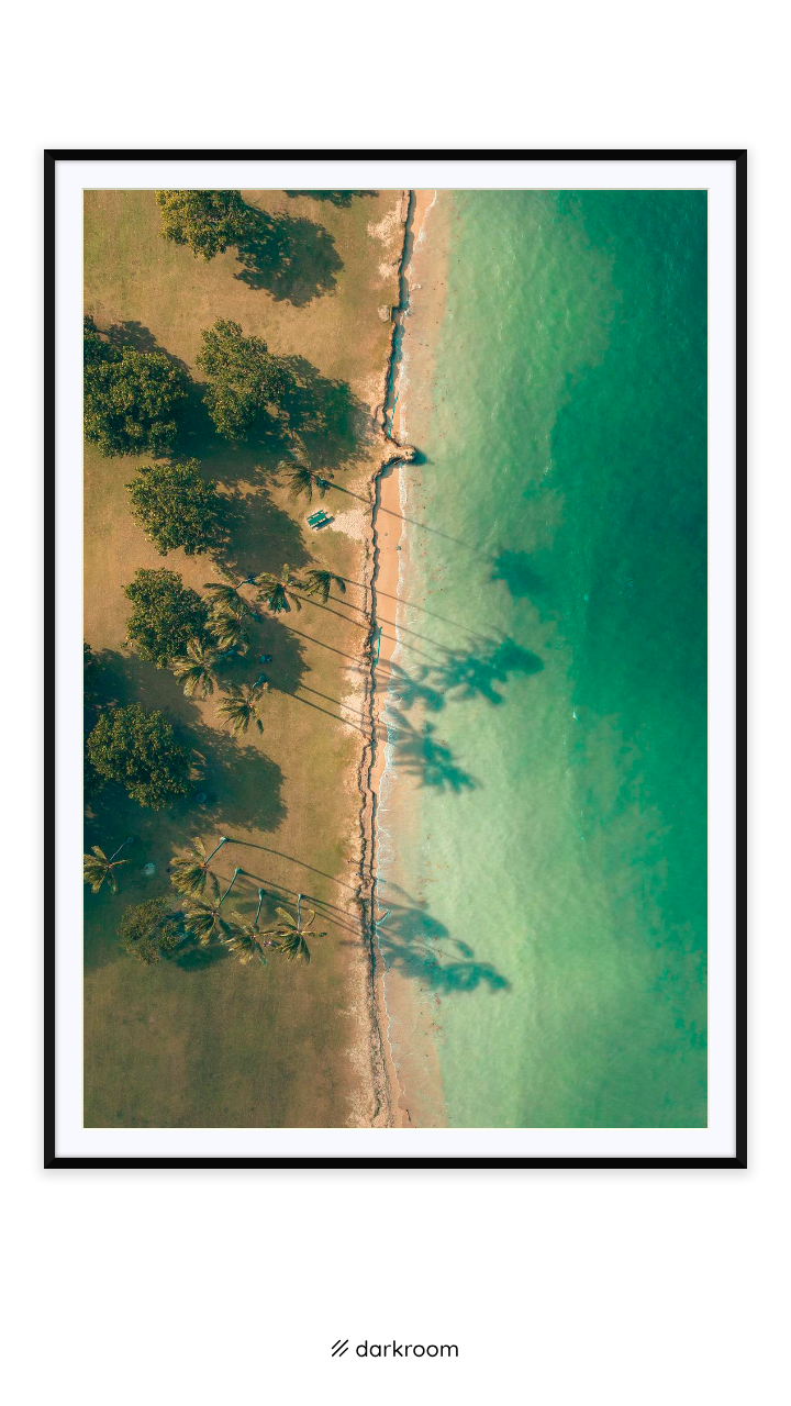 Black-framed print: Top-down photo of a palm-lined beach and turquoise water at Kualoa, Oahu